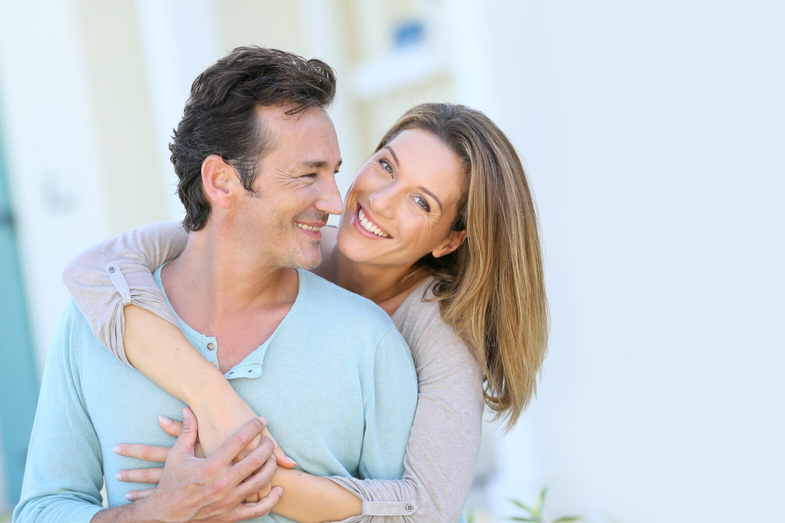 Middle-aged,Couple,Embracing,In,Front,Of,House